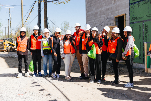  students on construction site orange protective gear